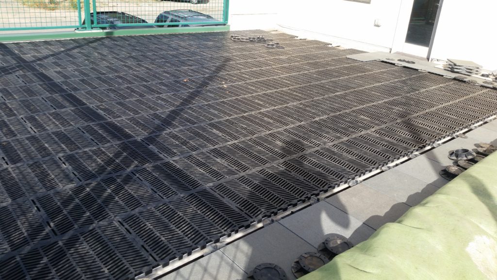 Here's the completed hog-slat flooring installation prior to rolling the turf back out.  The slatted panels are perfect for letting water drain down through the turf and then let the roofing below do the reast of the work.